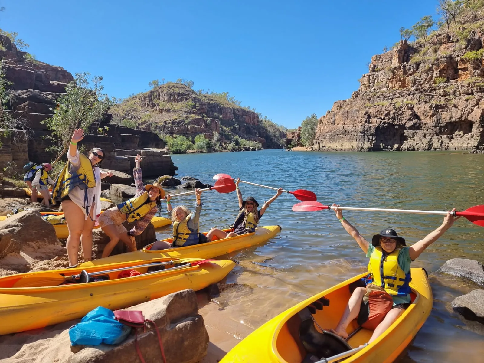 A retreat group kayaking a wild river