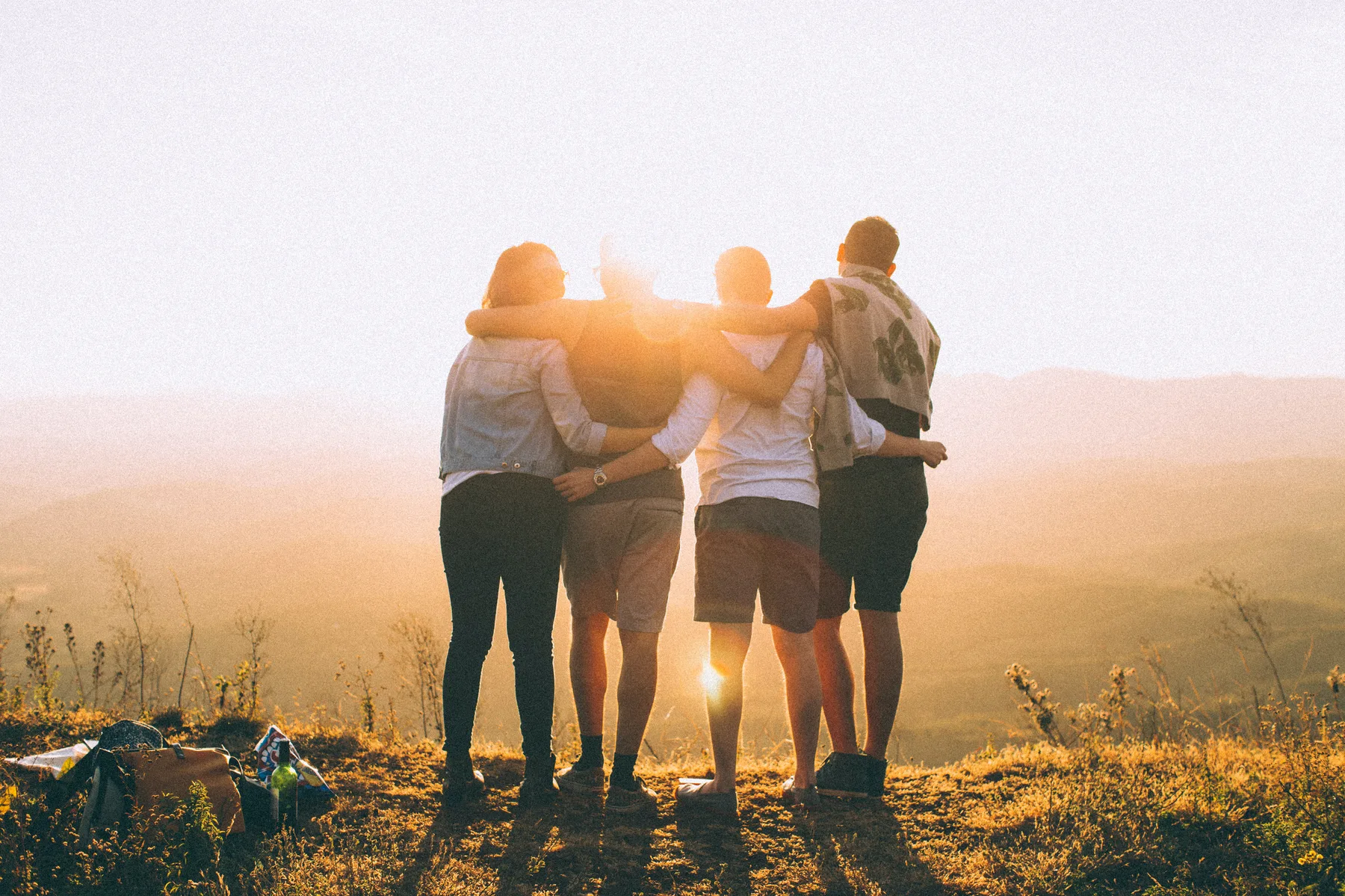 Women arm in arm watching the sunset